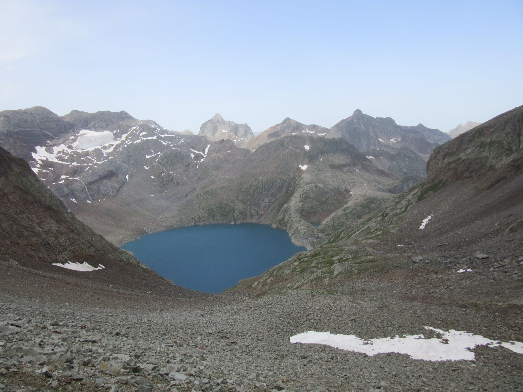 Descending from Col Inferieur de Literole towards Lac du Portillon (dam and refuge just visible to right); Gourgs-Blancs visible beyond.